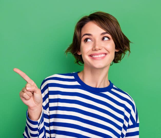 Brunette girl in stripey top pointing to the right