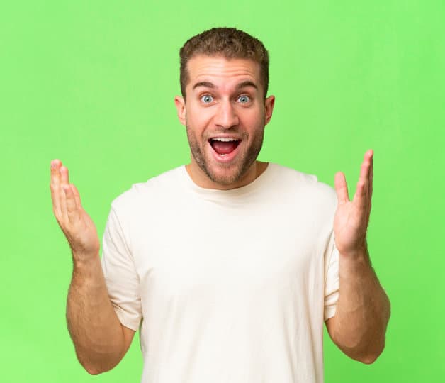 Wide eyed excited guy with hands open at shoulder height