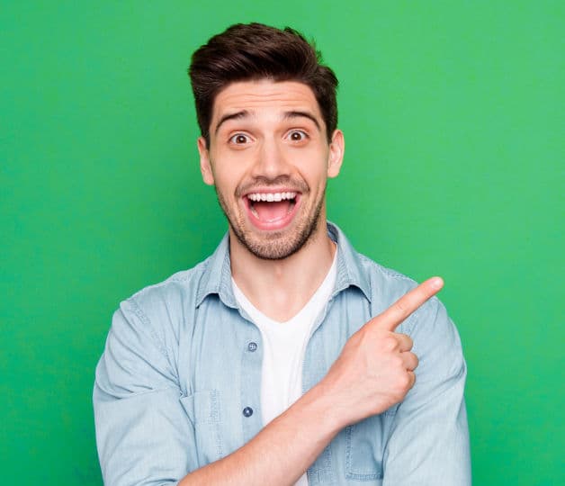 Excited man pointing over his left shoulder