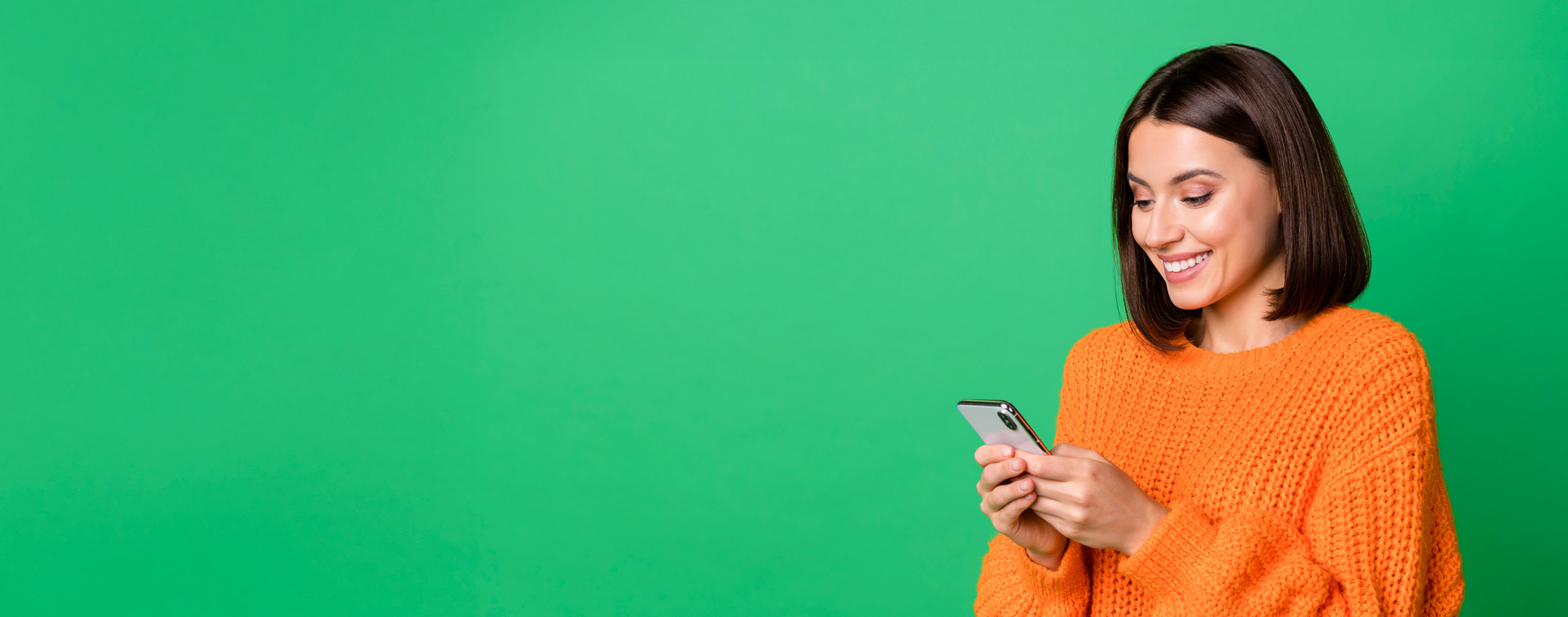 Brunette girl looking at her phone